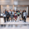 A color photo showing a group of people with award plaques